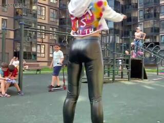 Blonde prostitute is showing her leather leggings ass in public!